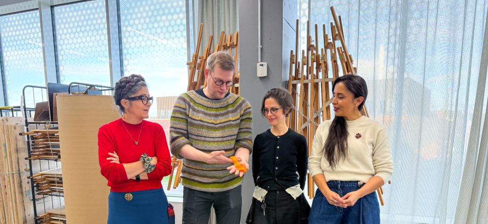 Four people in an arts studio