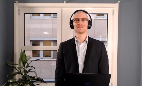 Man wearing a headset looking into the camera